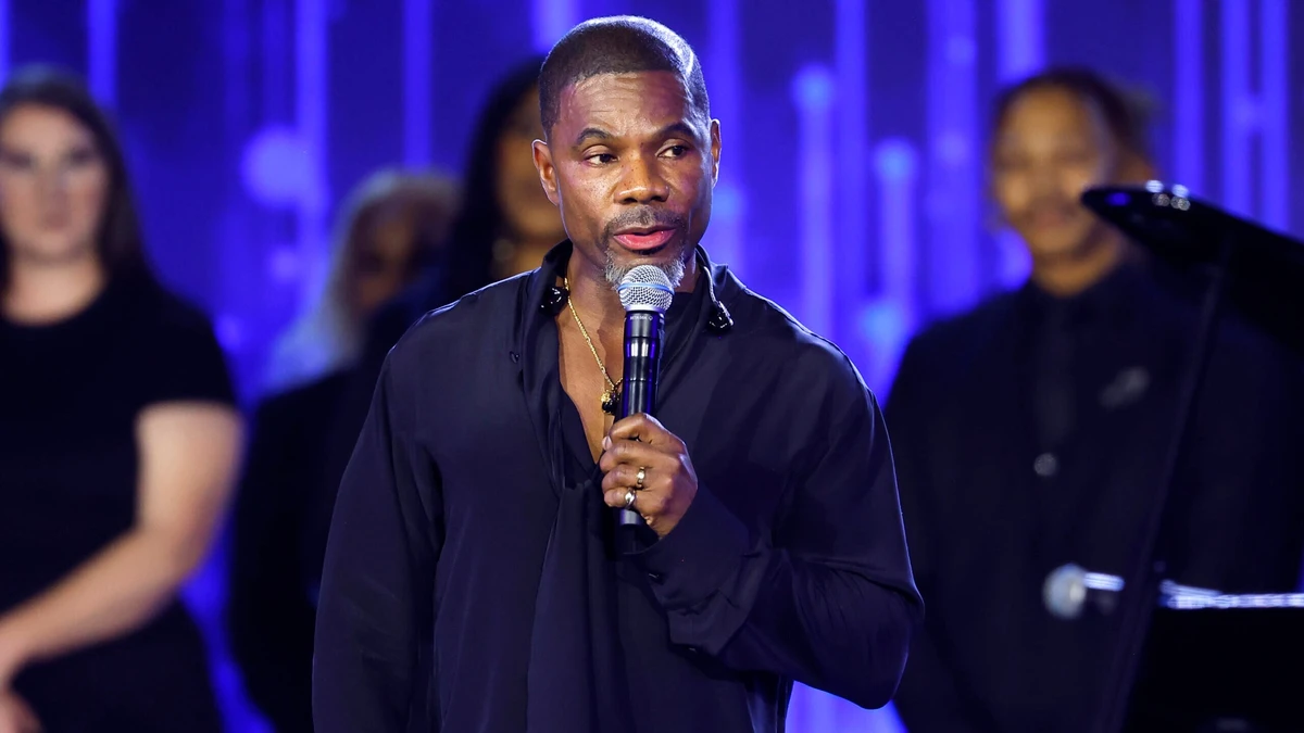 Kirk Franklin speaking onstage at the 2026 Recording Academy Honors